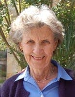 Outdoor head-and-shoulders portrait of an elderly woman smiling; used in the obituaries section as a supplemental family photo.