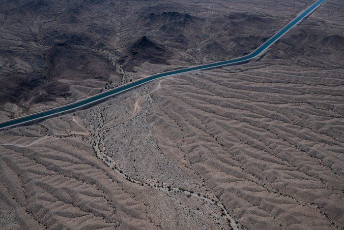Aerial photo of the CAP canal winding across the Arizona desert, illustrating the 336-mile aqueduct that carries Colorado River water to central and southern Arizona.