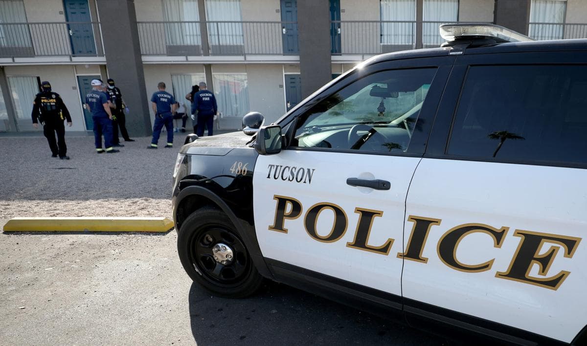 Tucson police SUV and first responders at an incident scene; authorities responded to a crash inside Davis‑Monthan Air Force Base that killed a 20‑year‑old woman.