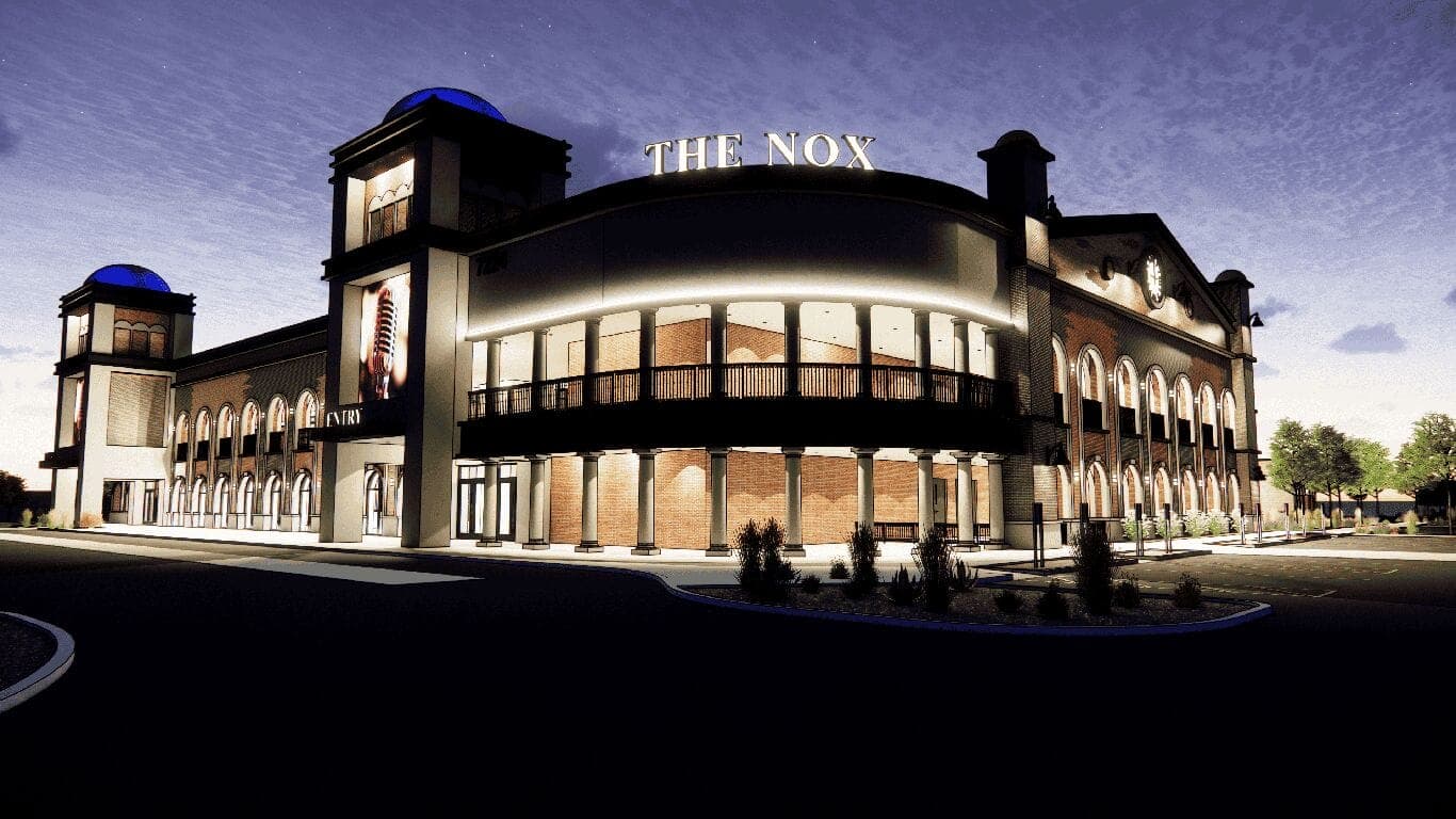 Nighttime exterior rendering of The Nox in Southeast Mesa, showing the illuminated ‘THE NOX’ marquee and the building's main entrance (rendering courtesy Adaptive Architects).