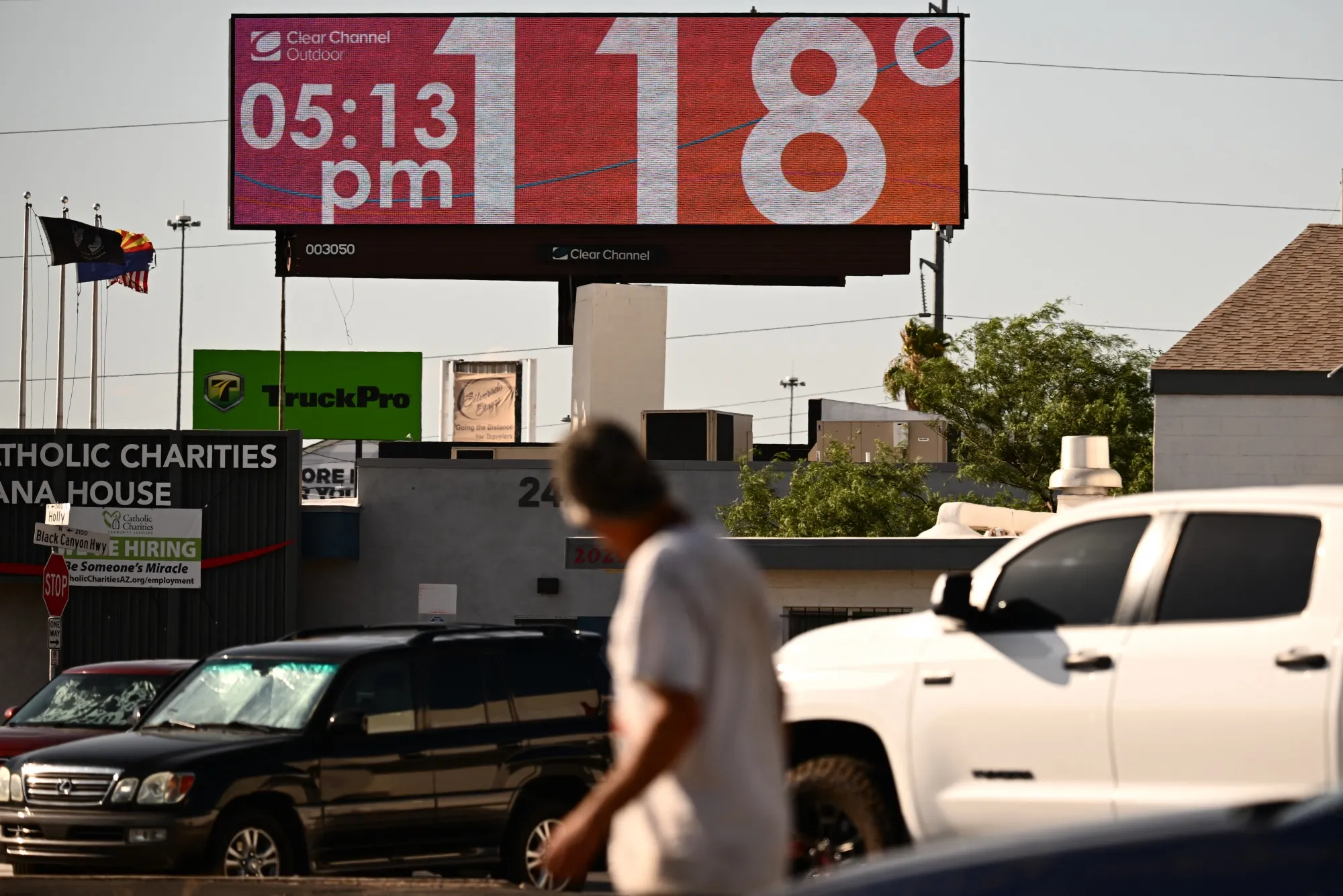 A digital billboard in an Arizona city displays 118°F, illustrating the extreme temperatures residents face as the state addresses heat-related risks.