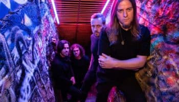 Wyrmhaven photographed in a graffiti-lined stairwell — the Tucson death‑metal band pictured while promoting their album 'Seasons of Gloom'.