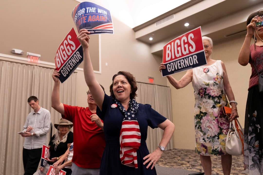 Supporters at a Biggs campaign event in Arizona raise 'Biggs Governor' signs during a Republican primary rally.