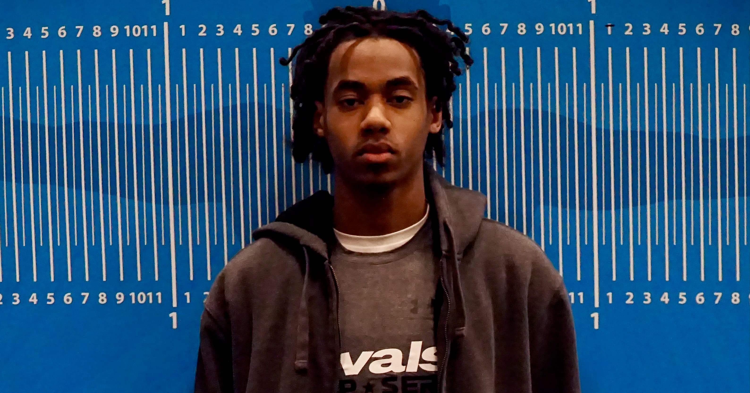 Portrait of a young man against a blue measurement-style backdrop; context for the story — the Phoenix Suns have signed guard Koby Brea to a two-way contract.