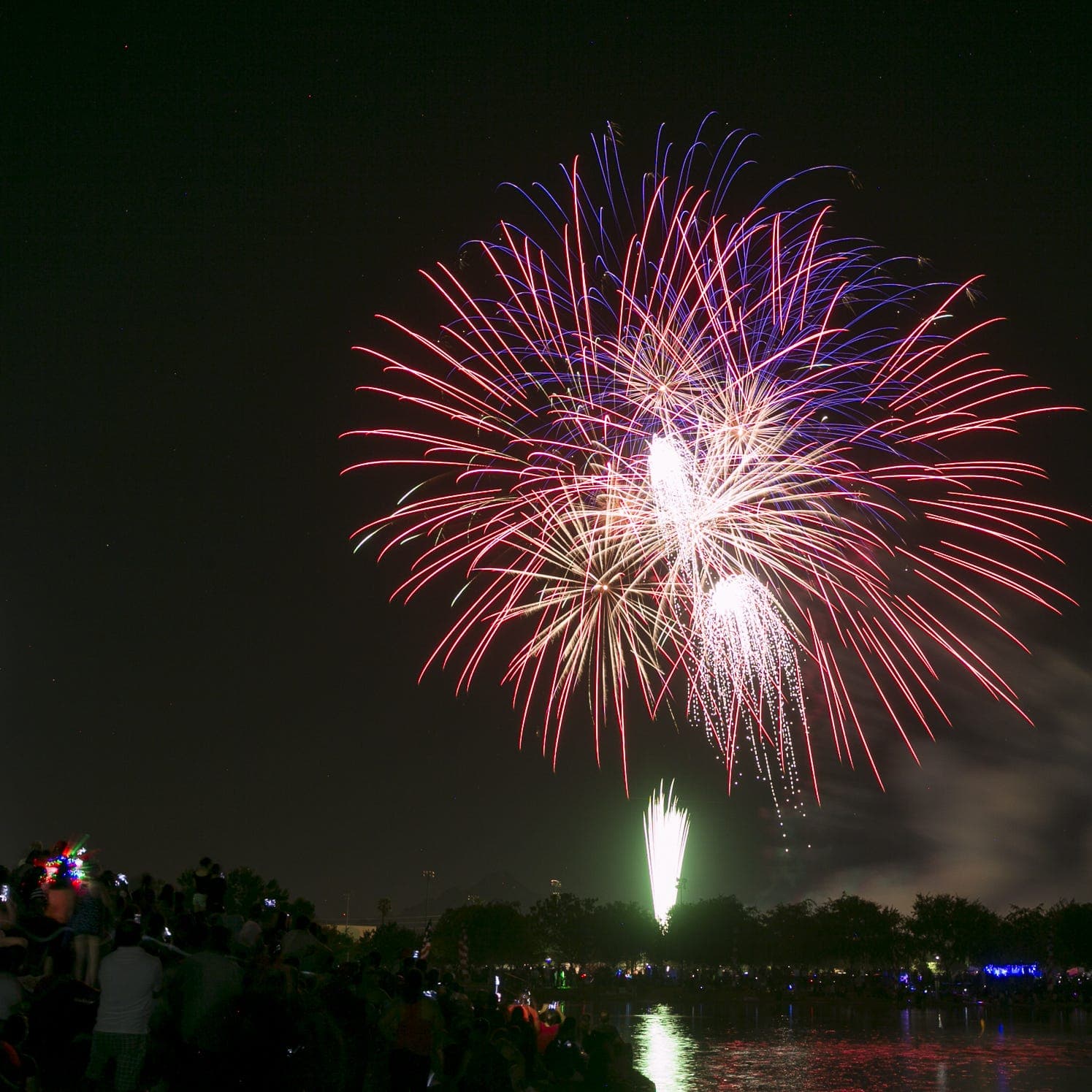 Fireworks light up the night sky as crowds watch at Steele Indian School Park during America 250 celebrations in Phoenix.