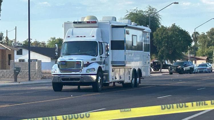 Shows: A police mobile command vehicle sits on a Gilbert street near crime-scene tape while officers continue their investigation into the deadly stabbing reported in the area.