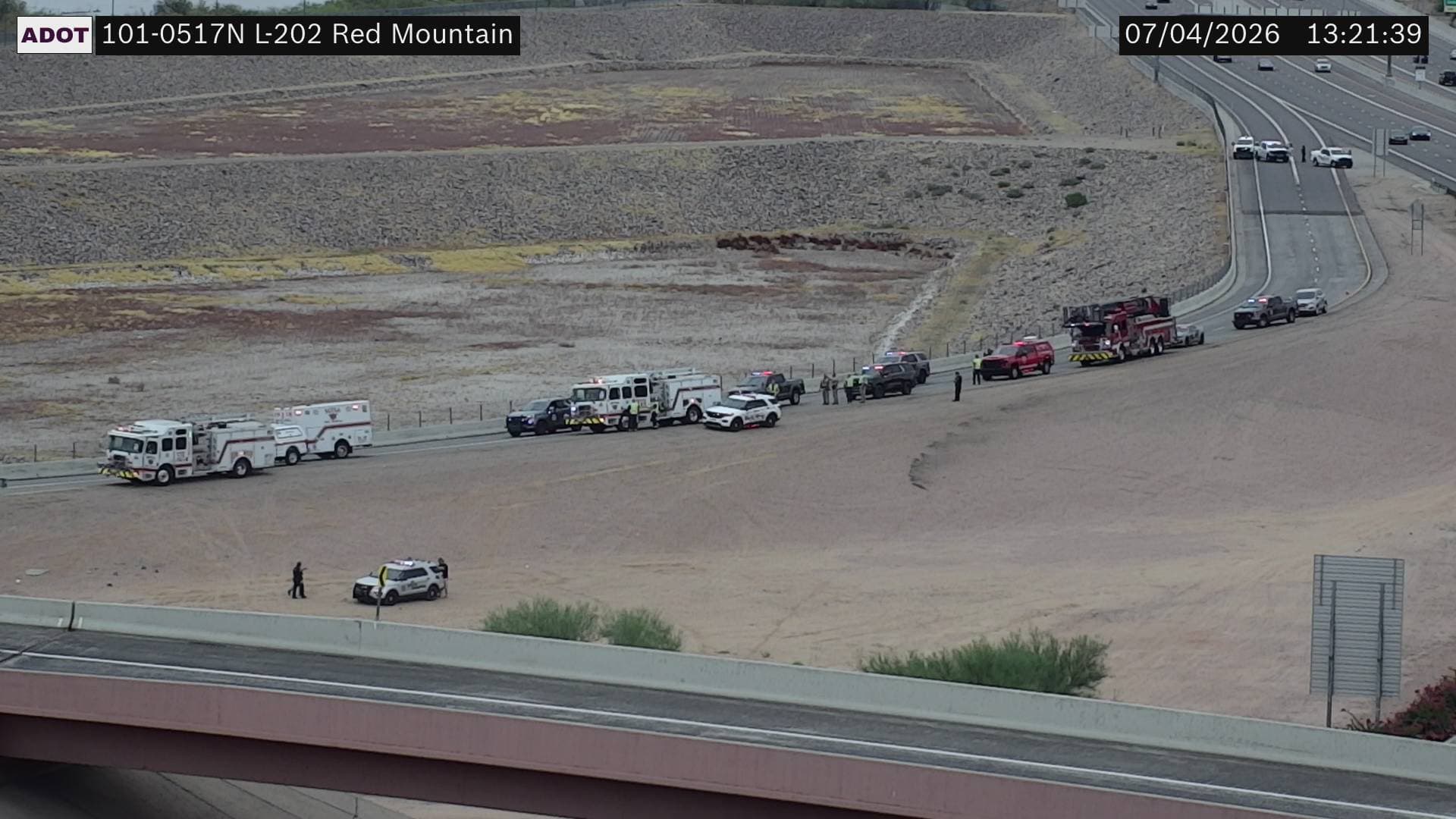 Emergency crews line the westbound Loop 202 to northbound Loop 101 transition ramp near Tempe on July 4, 2026, after a crash that closed the interchange.