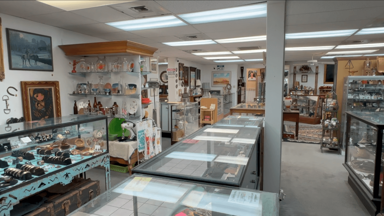Interior of American Antique Mall in Tucson, showing display cases and merchandise as the store prepares to close for the Grant Road widening project.